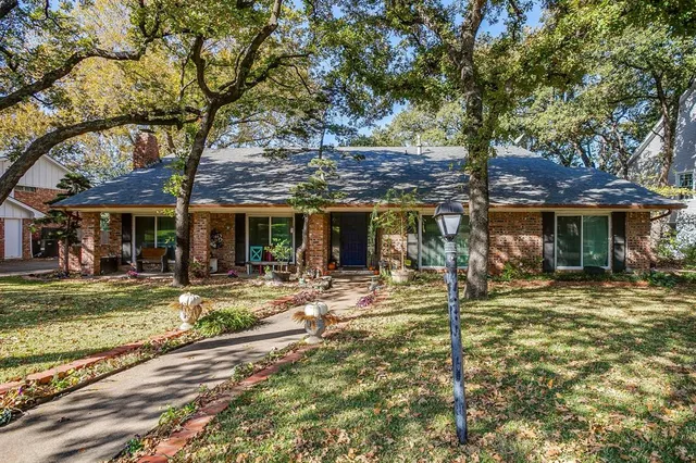 a view of a house with backyard sitting area and garden