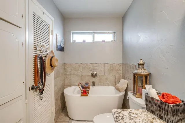 a bathroom with a bathtub and a sink
