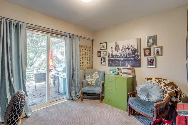 a living room with furniture and a floor to ceiling window