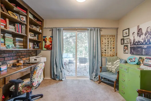 a view of a livingroom with fridge and workspace