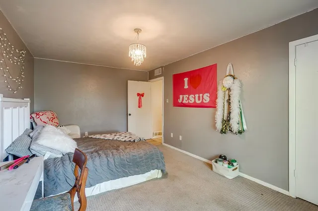 a bedroom with furniture and a chandelier
