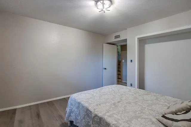 a bedroom with a bed and a dresser