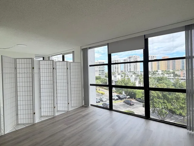 wooden floor in an empty room with a large window
