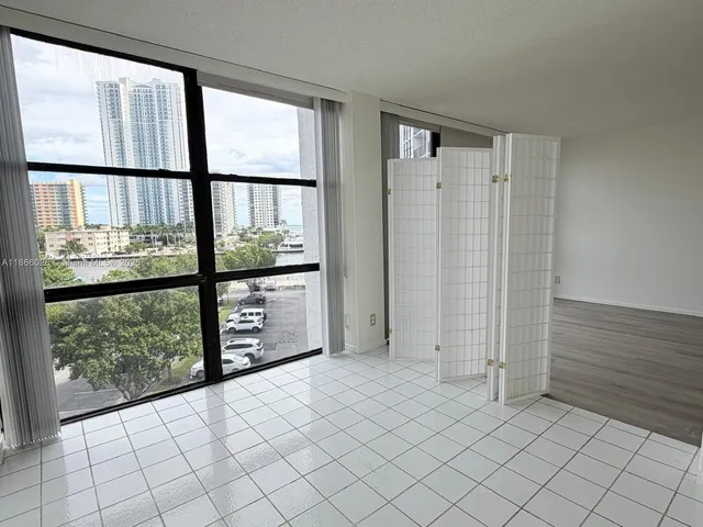 an empty room with windows and closet