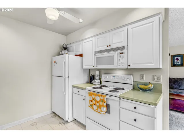a kitchen with a refrigerator a stove a microwave and cabinets
