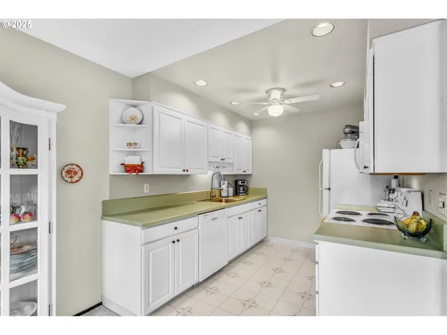 a kitchen with cabinets a sink and appliances