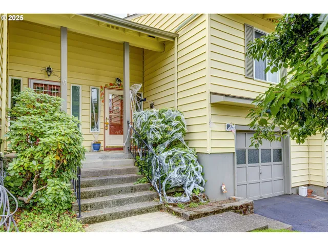 a view of a house with potted plants