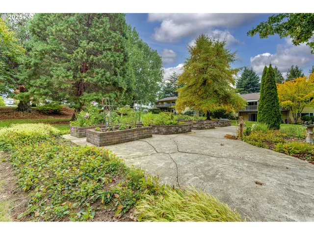 a backyard of a house with a garden and outdoor seating