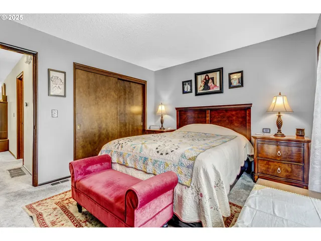 a bedroom with a bed and a lamp