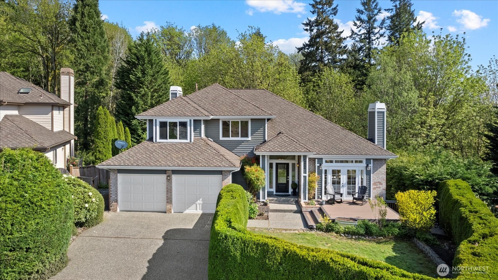 a aerial view of a house with swimming pool next to a yard