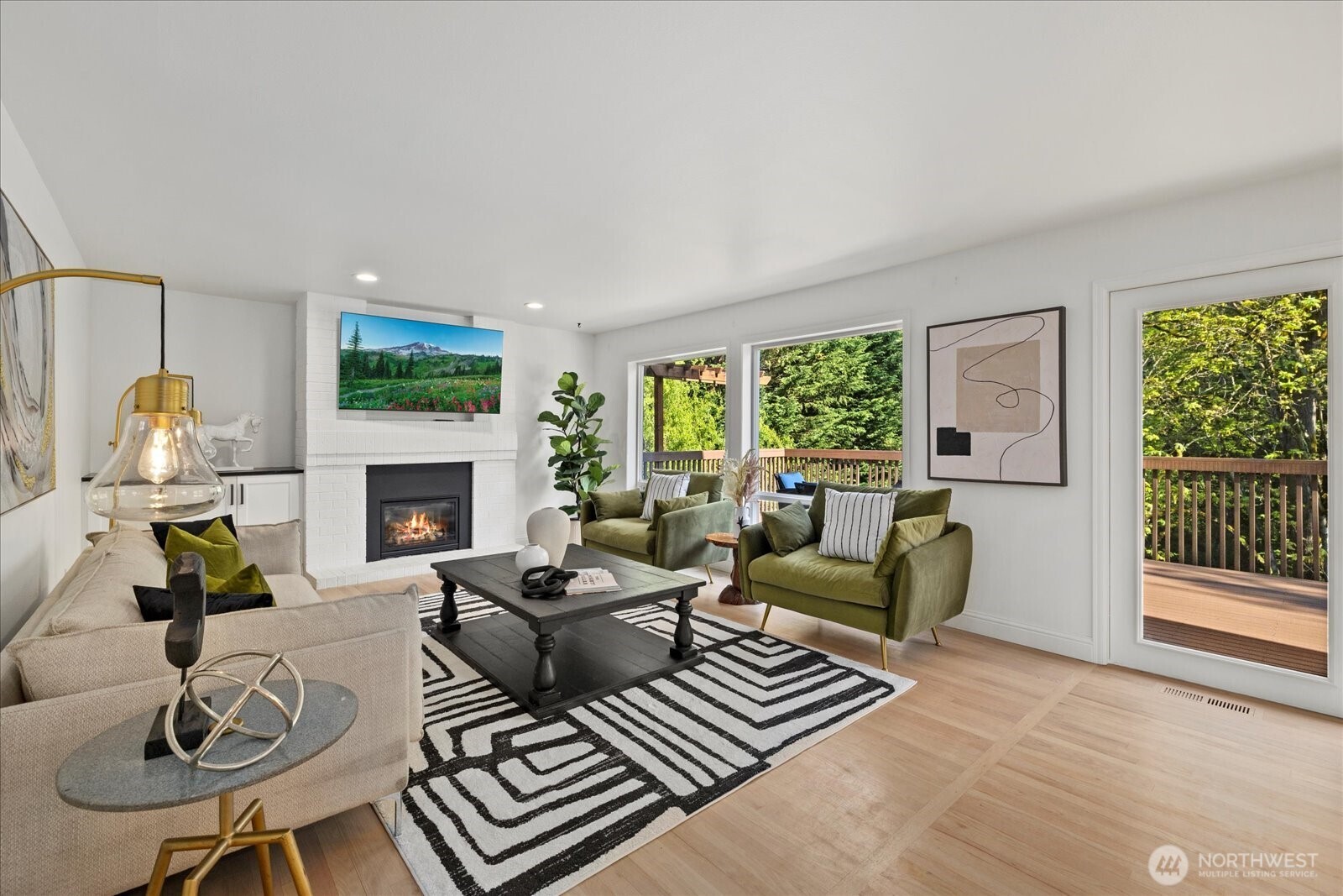 10906 Northeast 197th Street Bothell, WA 98011 - Photo 16 of 38 a living room with furniture a fireplace and a floor to ceiling window