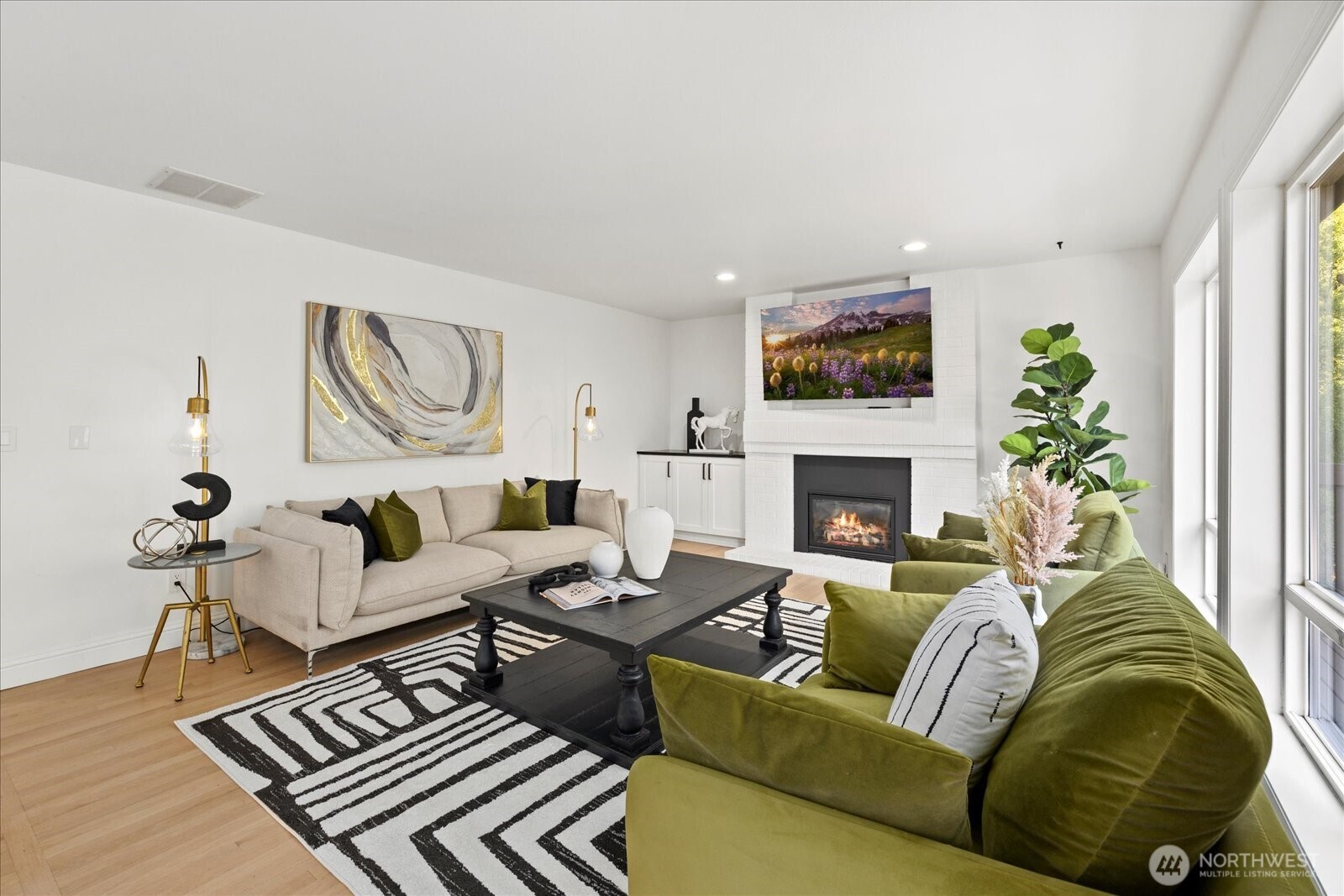 10906 Northeast 197th Street Bothell, WA 98011 - Photo 17 of 38 a living room with furniture a fireplace and a flat screen tv