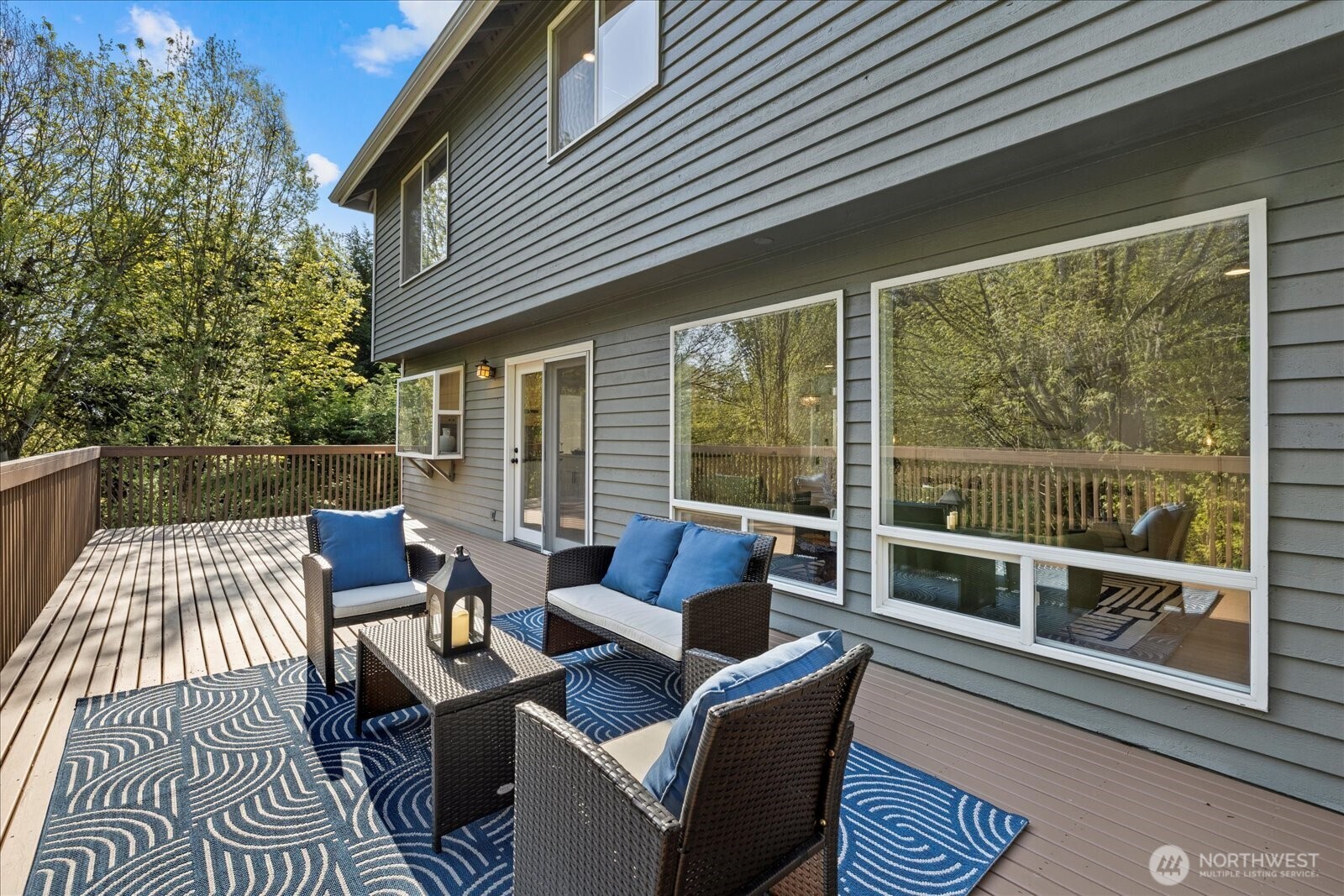 10906 Northeast 197th Street Bothell, WA 98011 - Photo 20 of 38 a view of a patio with couches chairs and wooden floor