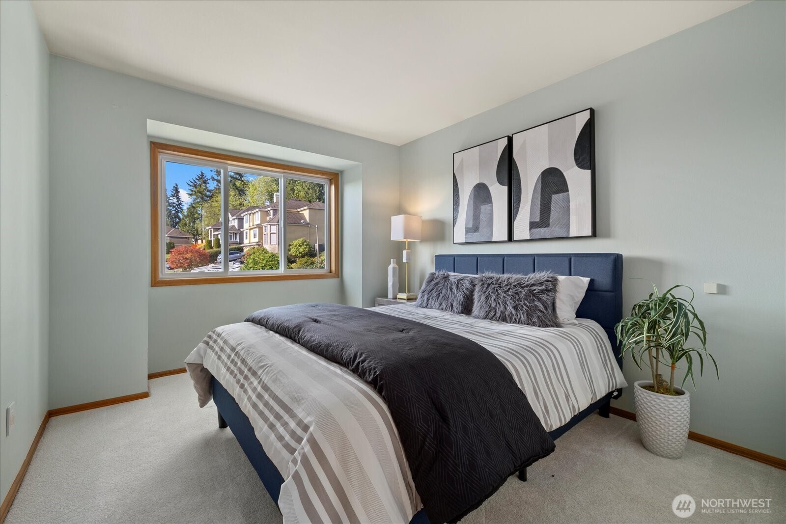 10906 Northeast 197th Street Bothell, WA 98011 - Photo 26 of 38 a bedroom with a bed and painting on the wall