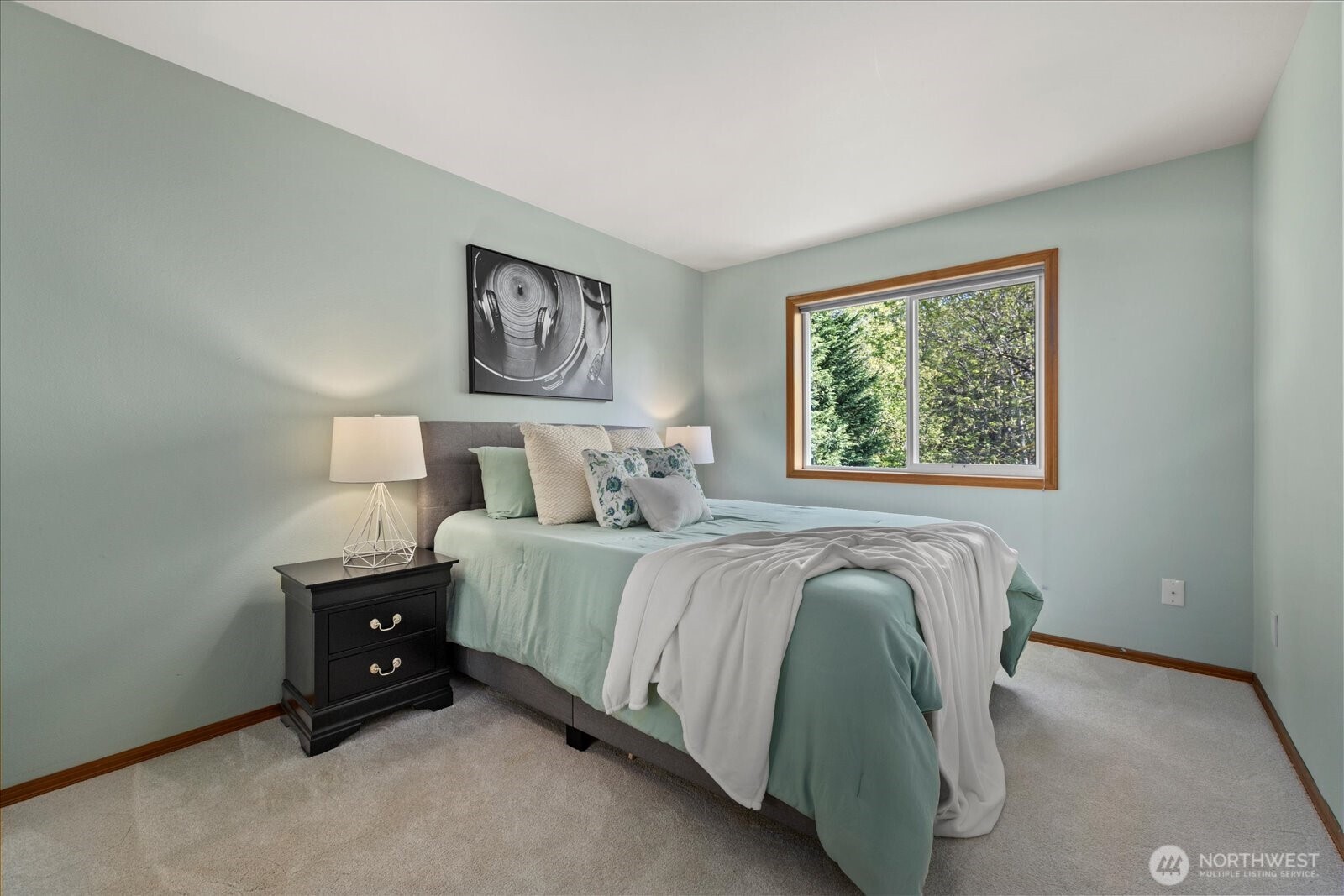 10906 Northeast 197th Street Bothell, WA 98011 - Photo 27 of 38 a spacious bedroom with a bed and a window