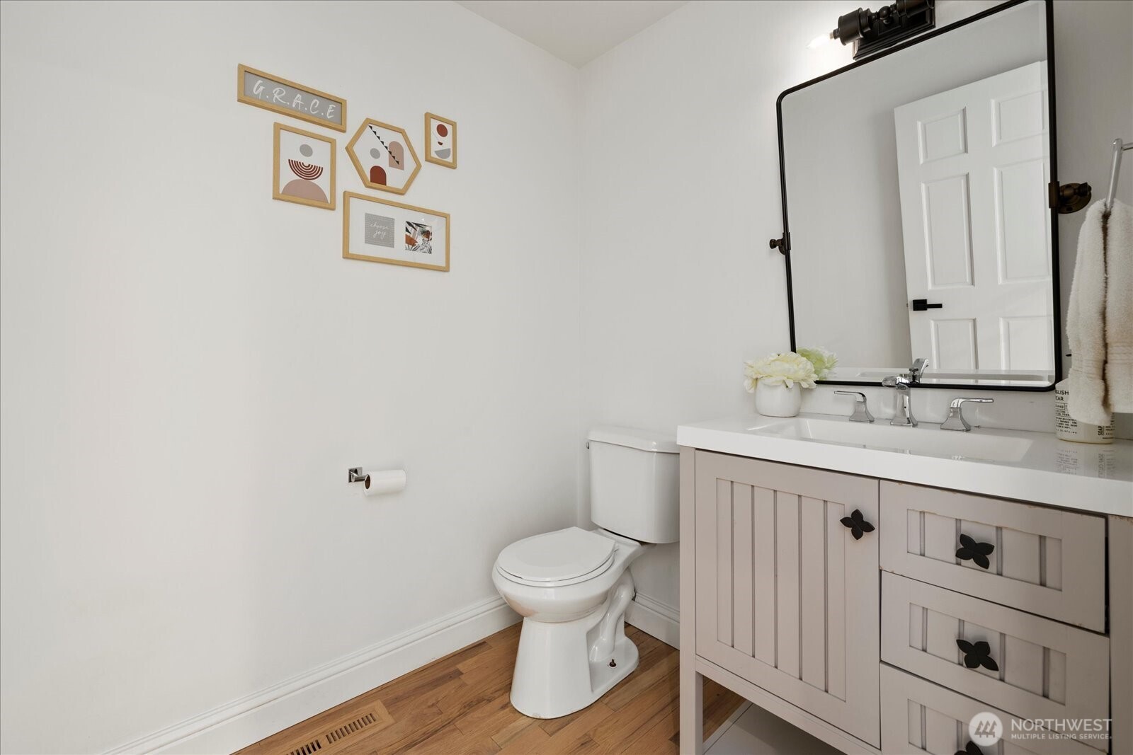 10906 Northeast 197th Street Bothell, WA 98011 - Photo 35 of 38 a bathroom with a toilet a sink and a mirror