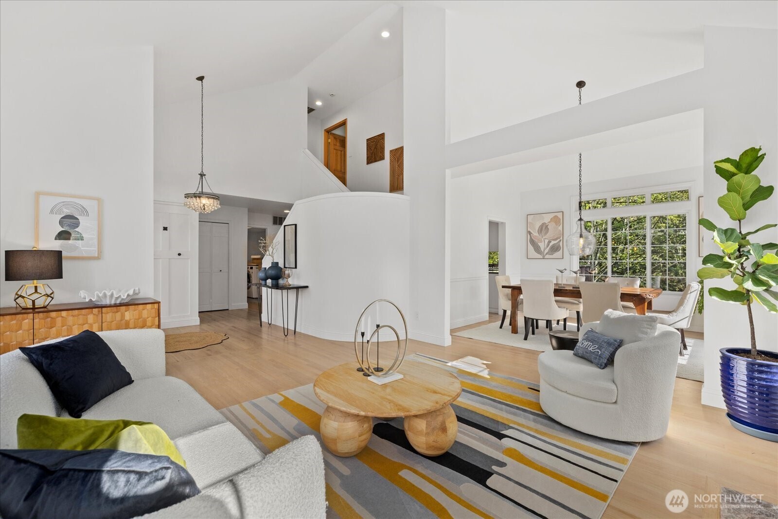 10906 Northeast 197th Street Bothell, WA 98011 - Photo 8 of 38 a living room with furniture and a chandelier