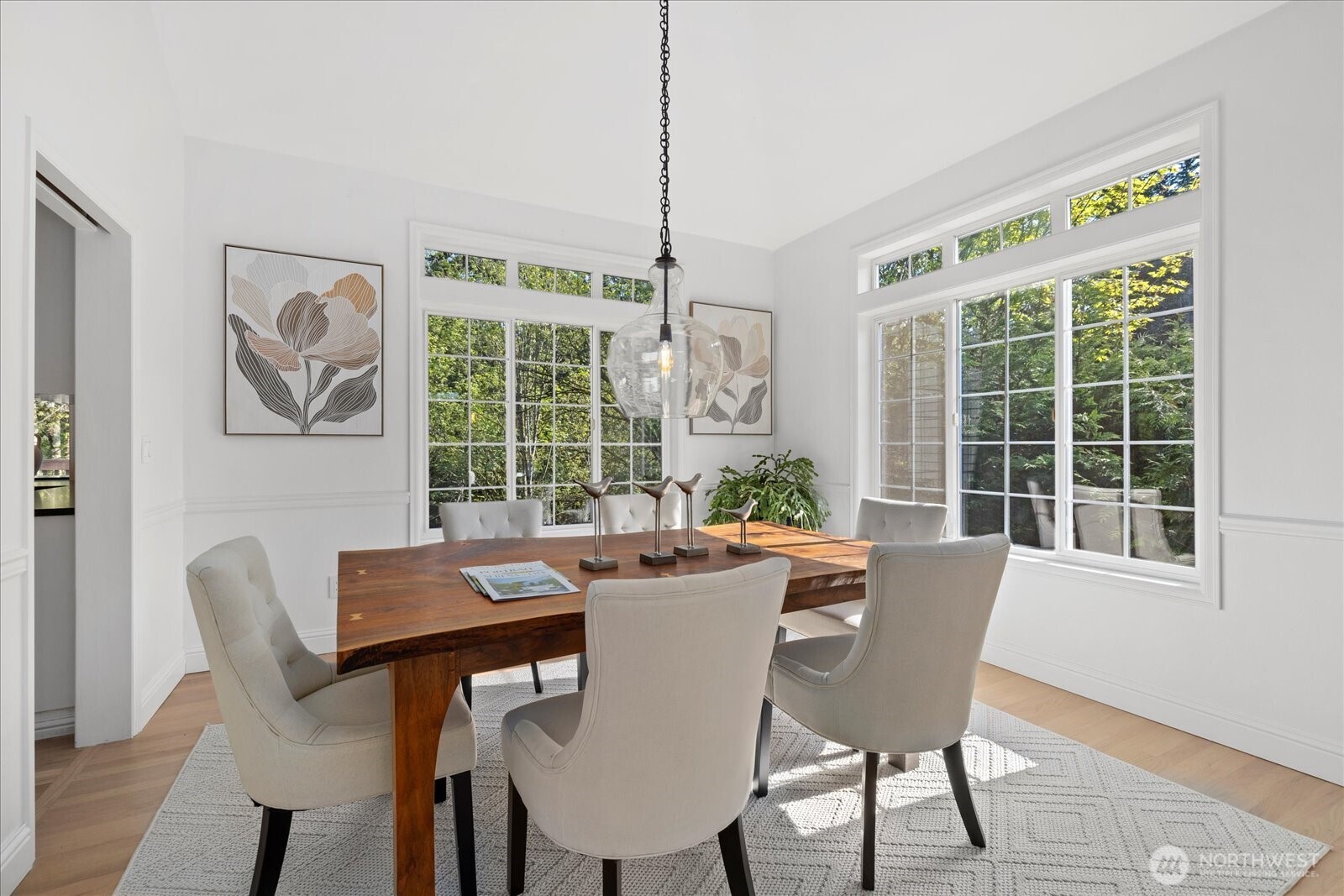 10906 Northeast 197th Street Bothell, WA 98011 - Photo 10 of 38 a dining room with furniture a chandelier and wooden floor