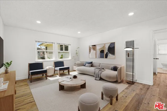 a living room with furniture and wooden floor