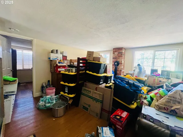 a living room filled with furniture and a dining table with wooden floor