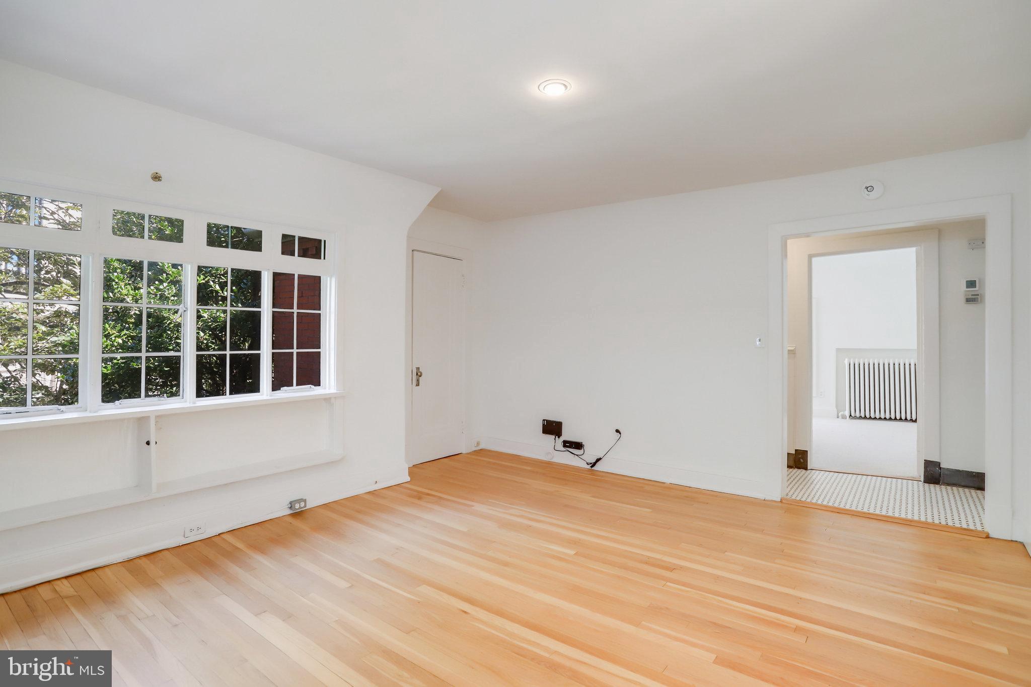 1633 16th Street Northwest Washington, DC 20009 - Photo 105 of 130 a view of empty room with wooden floor and fan