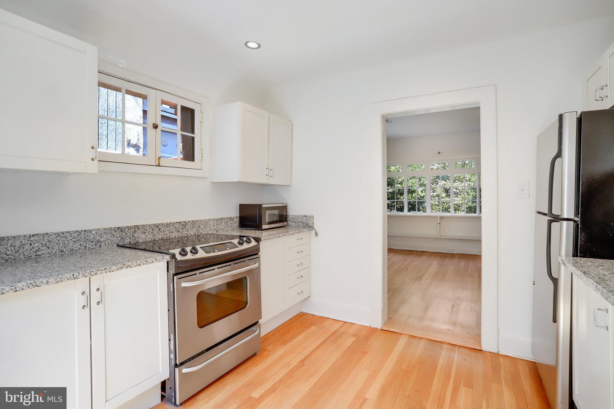 1633 16th Street Northwest Washington, DC 20009 - Photo 109 of 130 a kitchen with a stove top oven and refrigerator