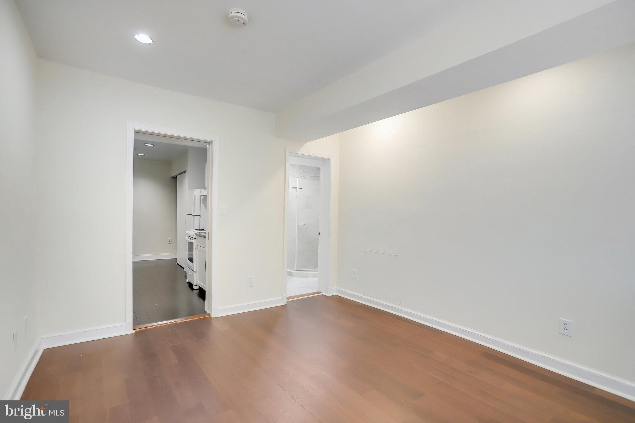 1633 16th Street Northwest Washington, DC 20009 - Photo 119 of 130 an empty room with wooden floor and windows