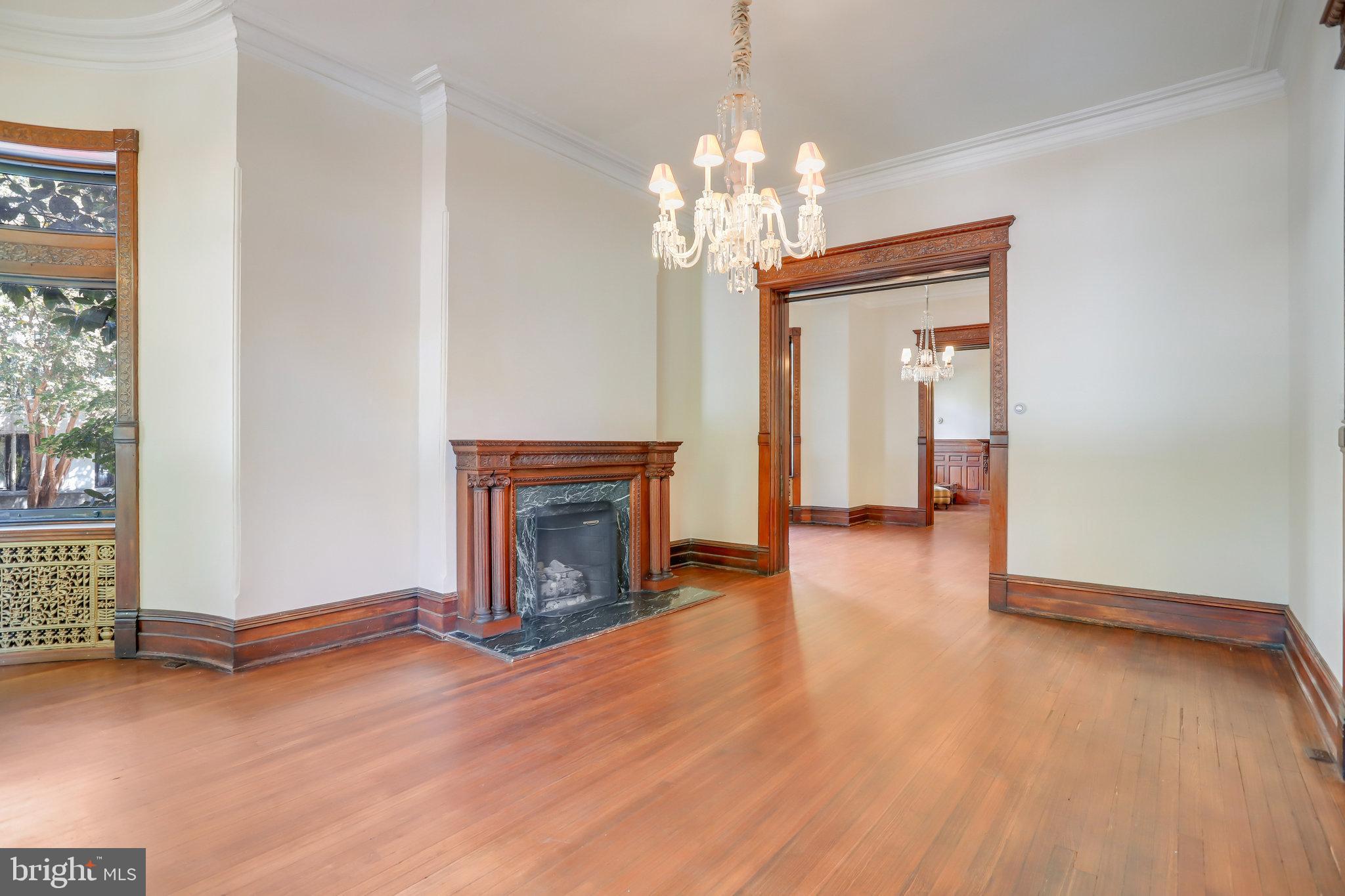 1633 16th Street Northwest Washington, DC 20009 - Photo 14 of 130 a view of a livingroom with a fireplace wooden floor and a chandelier