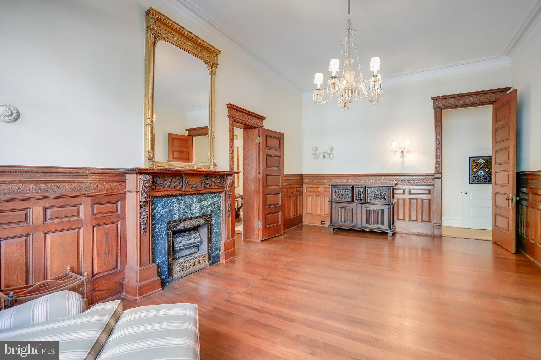 1633 16th Street Northwest Washington, DC 20009 - Photo 24 of 130 a view of a livingroom with a fireplace a chandelier and wooden floor
