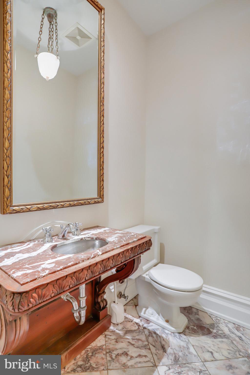 1633 16th Street Northwest Washington, DC 20009 - Photo 28 of 130 a bathroom with a granite countertop toilet sink a mirror and vanity