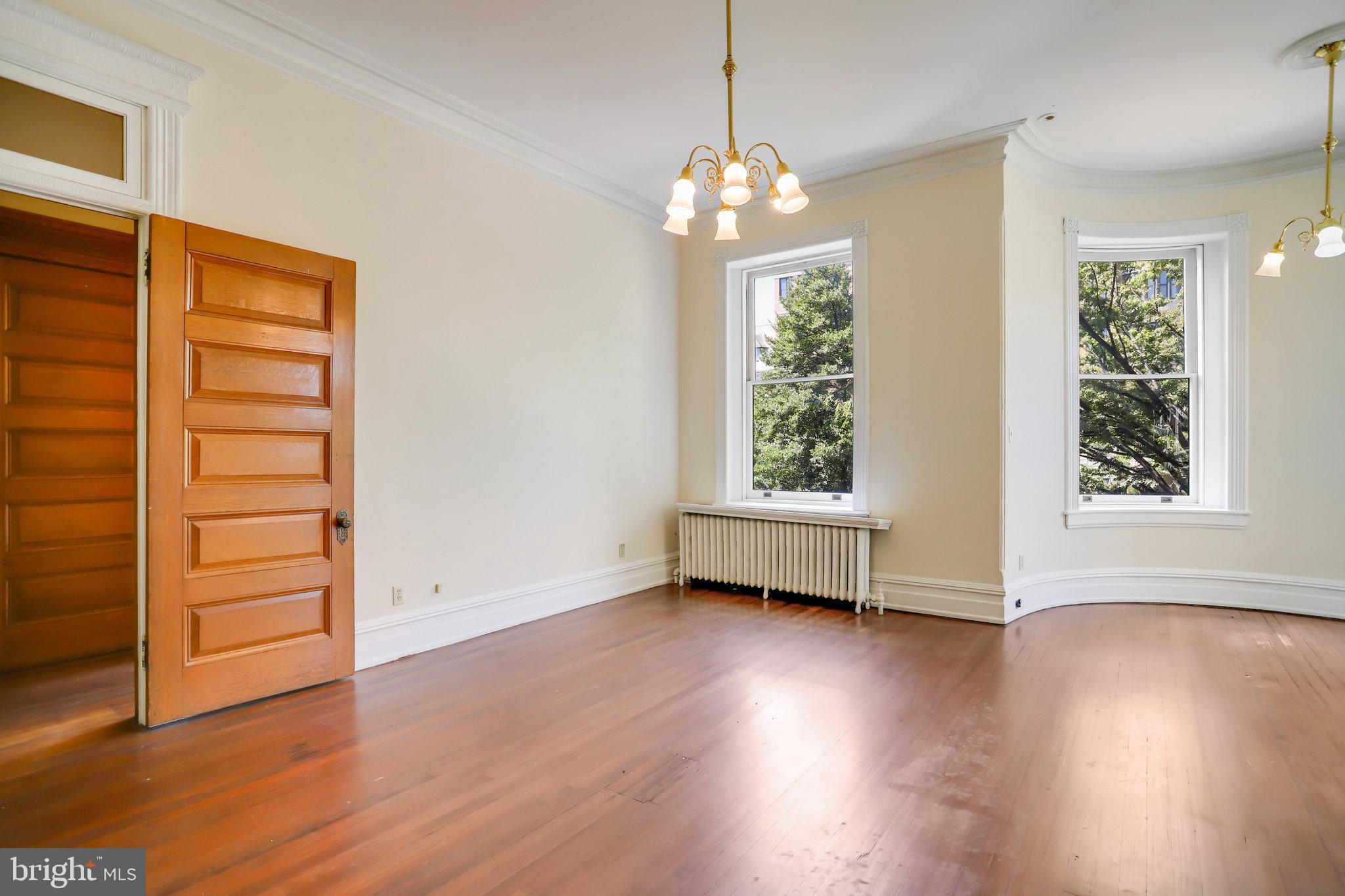 1633 16th Street Northwest Washington, DC 20009 - Photo 45 of 130 an empty room with wooden floor and windows