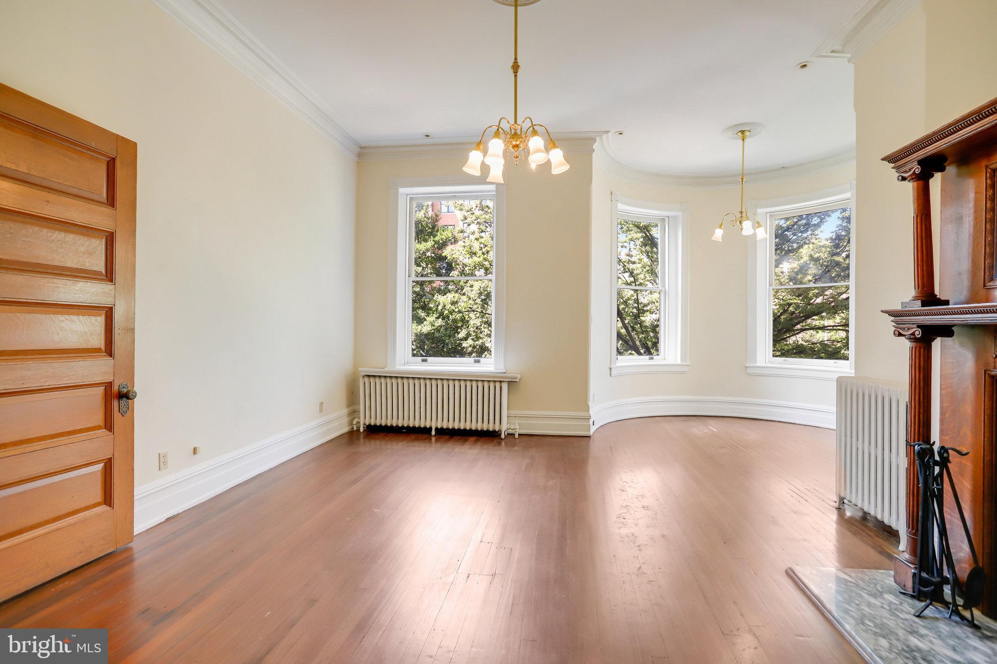 1633 16th Street Northwest Washington, DC 20009 - Photo 46 of 130 a view of an empty room with wooden floor and a window