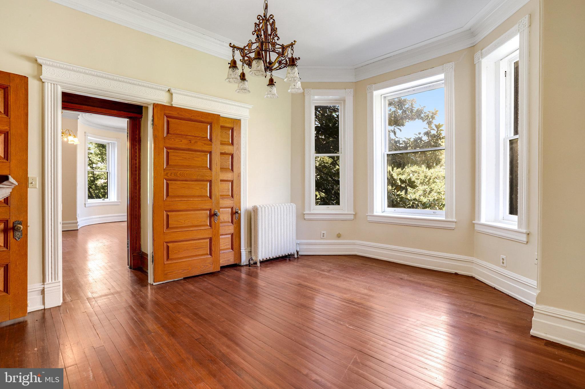 1633 16th Street Northwest Washington, DC 20009 - Photo 50 of 130 a view of an empty room with wooden floor and a window