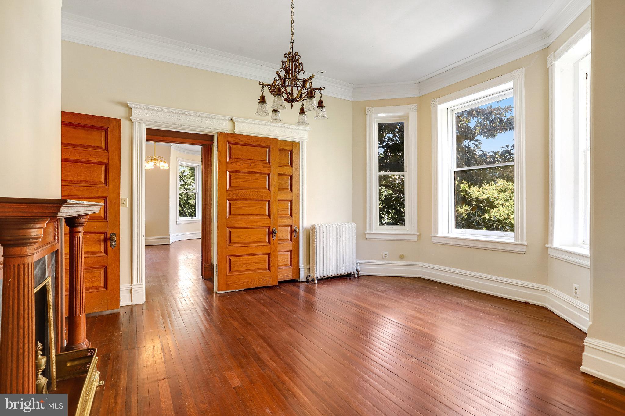1633 16th Street Northwest Washington, DC 20009 - Photo 51 of 130 a view of an empty room with wooden floor and a window