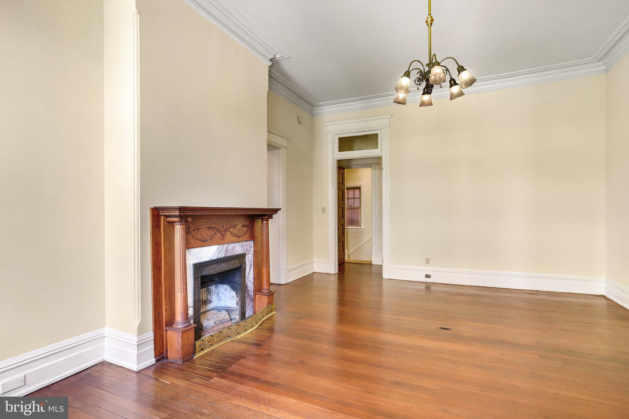 1633 16th Street Northwest Washington, DC 20009 - Photo 54 of 130 a view of an empty room with wooden floor and a fireplace
