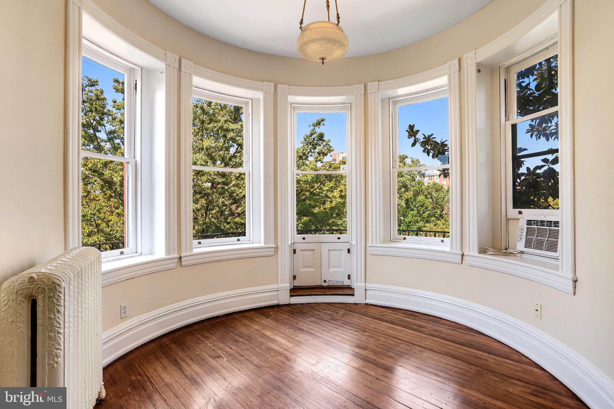 1633 16th Street Northwest Washington, DC 20009 - Photo 68 of 130 a view of an empty room with wooden floor and a window