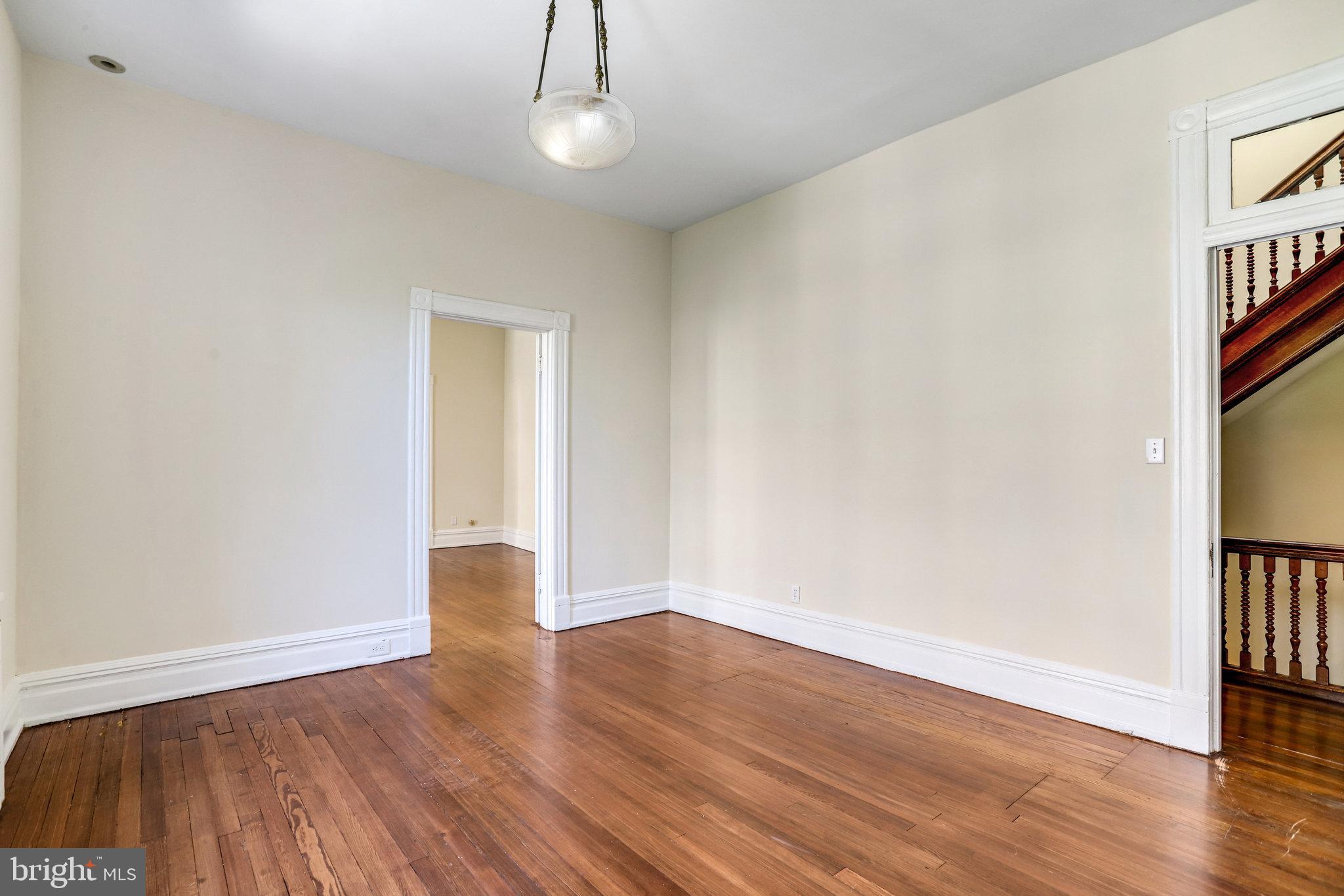 1633 16th Street Northwest Washington, DC 20009 - Photo 72 of 130 a view of an empty room with wooden floor and a window