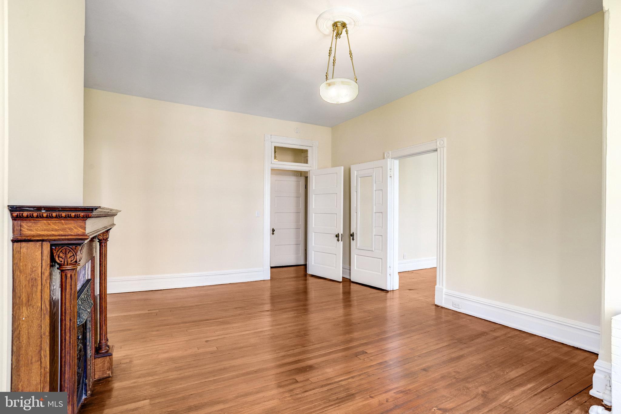 1633 16th Street Northwest Washington, DC 20009 - Photo 77 of 130 a view of empty room with wooden floor and fan