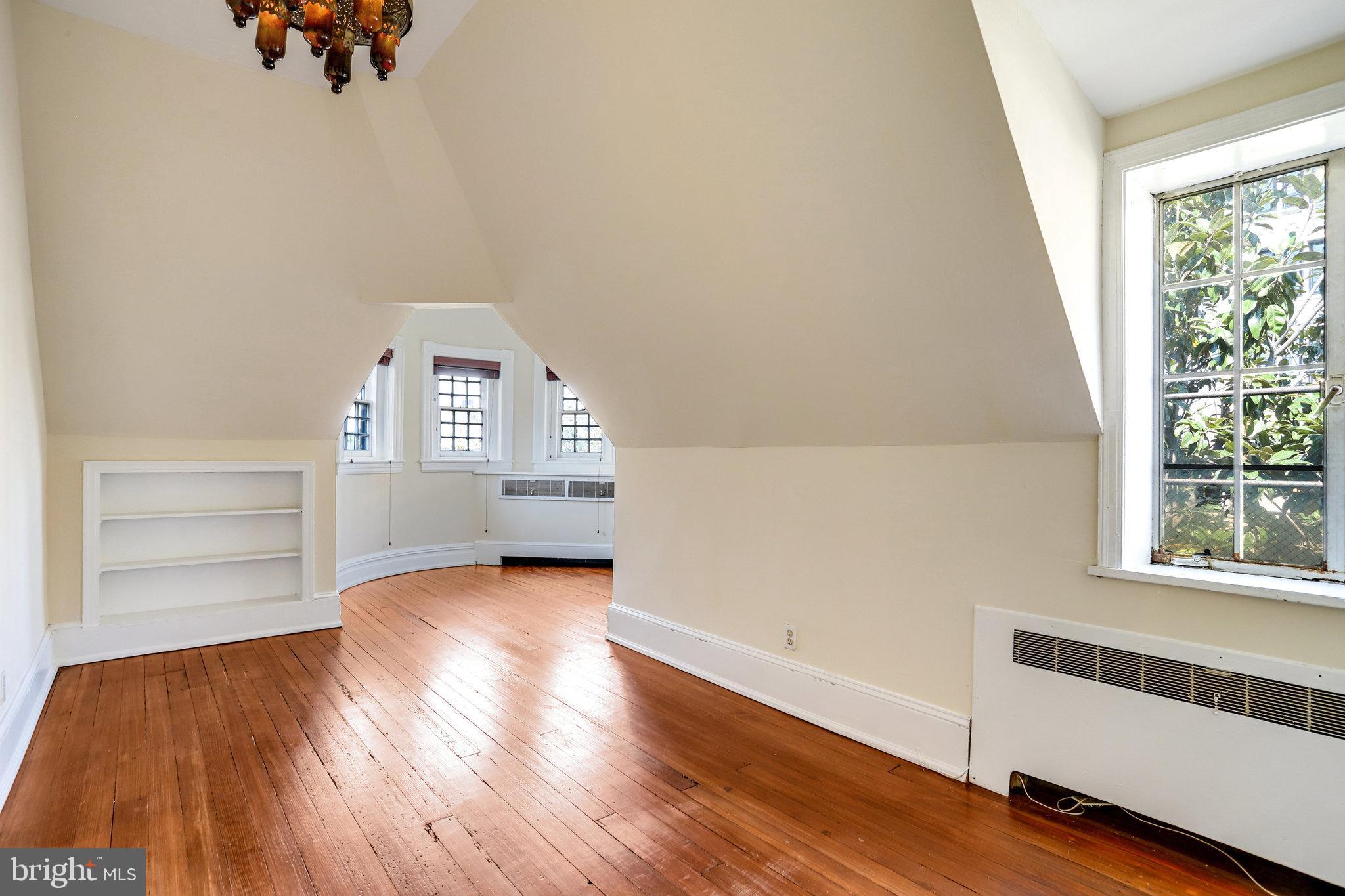 1633 16th Street Northwest Washington, DC 20009 - Photo 91 of 130 an empty room with wooden floor cabinet and windows