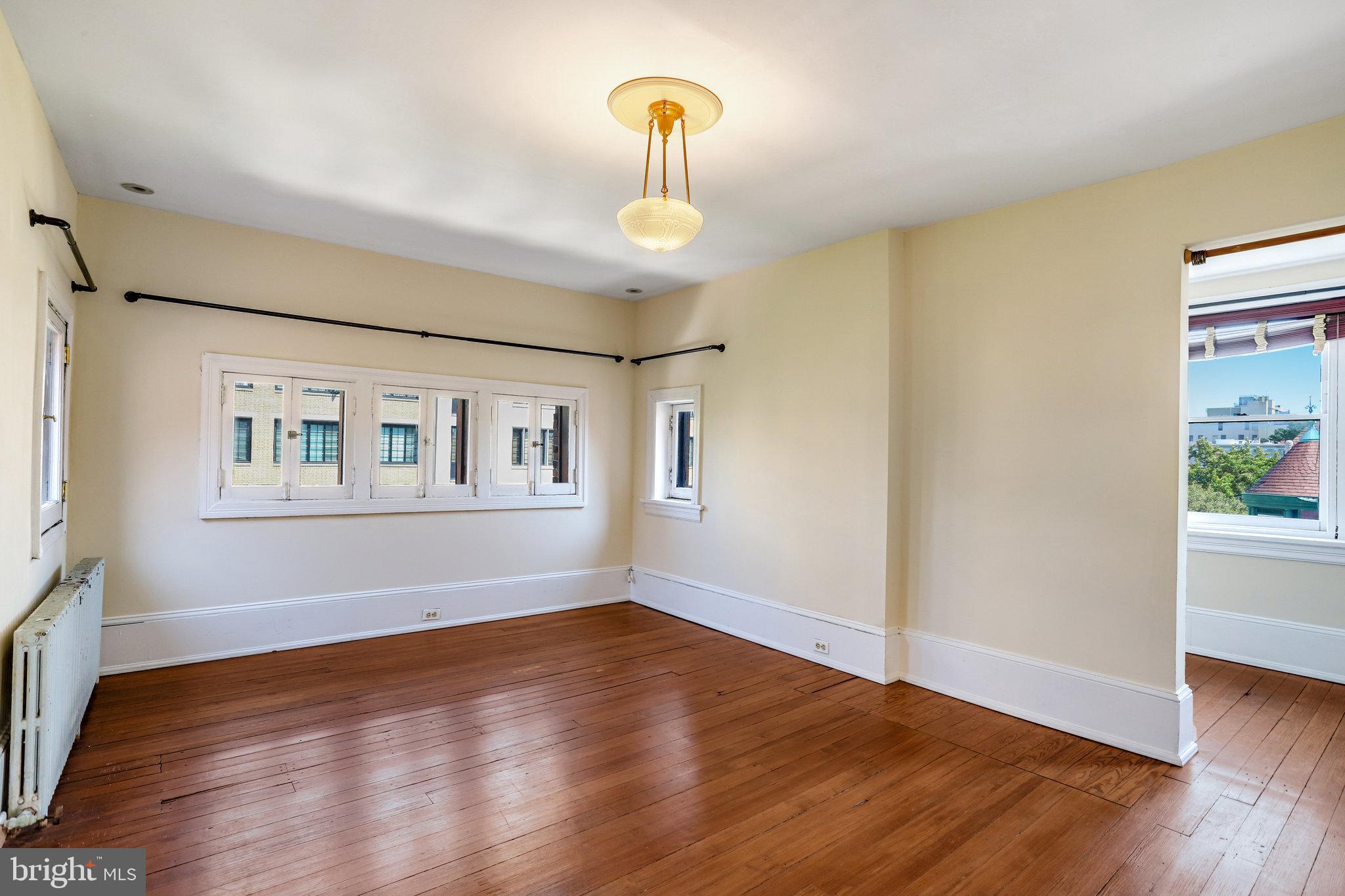 1633 16th Street Northwest Washington, DC 20009 - Photo 95 of 130 a view of an empty room with window and wooden floor
