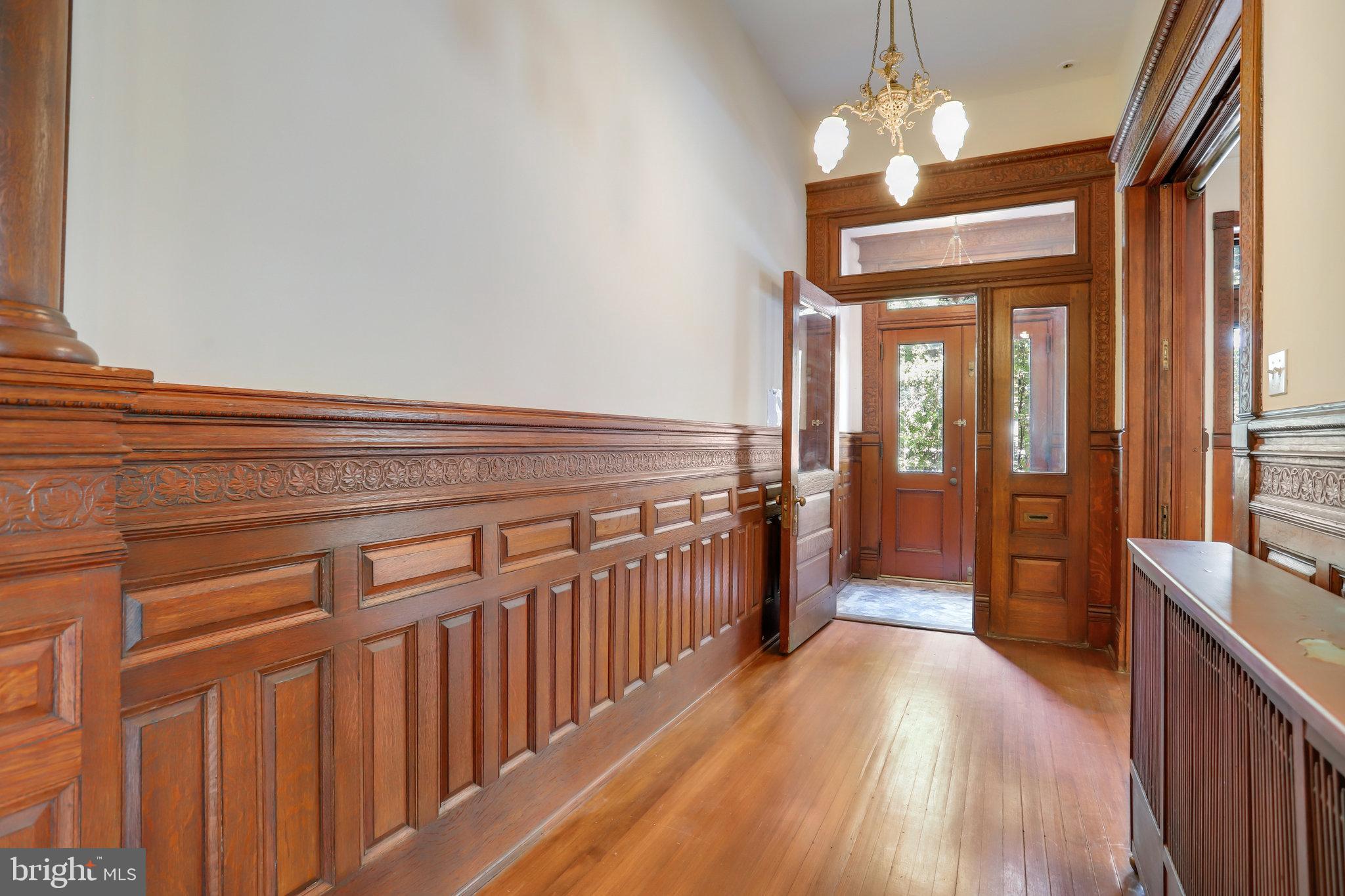 1633 16th Street Northwest Washington, DC 20009 - Photo 10 of 130 a view of a hallway with wooden floor and chandelier