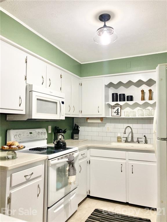 181 Echo Drive Laurel Park, NC 28739 - Photo 9 of 28 a kitchen with cabinets appliances and a sink