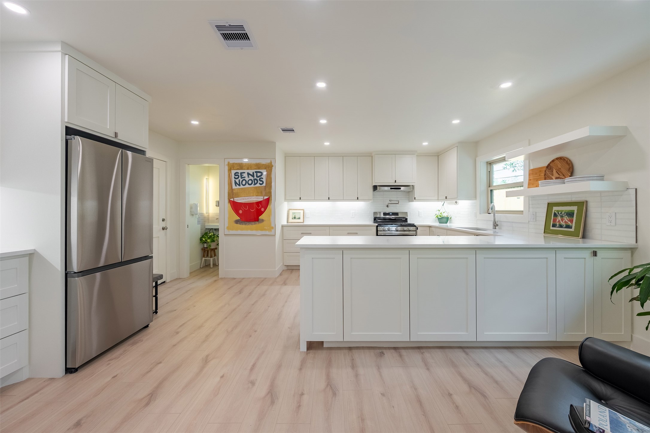 5326 Carew Street Houston, TX 77096 - Photo 12 of 30 a kitchen with refrigerator cabinets and wooden floor