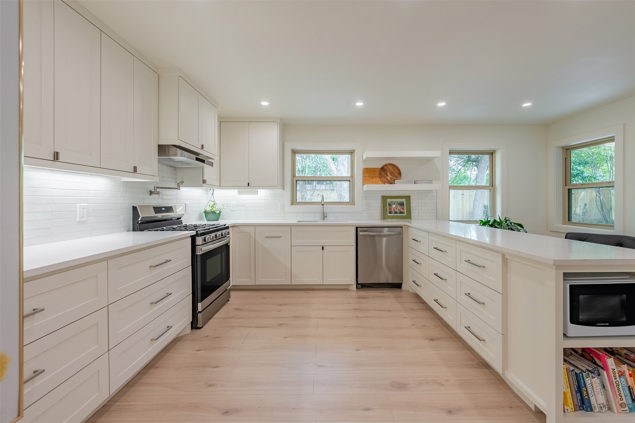5326 Carew Street Houston, TX 77096 - Photo 15 of 30 a kitchen with white cabinets and white appliances