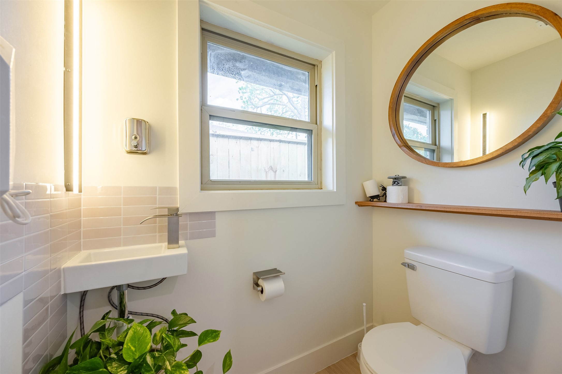 5326 Carew Street Houston, TX 77096 - Photo 16 of 30 a bathroom with a toilet a sink and mirror