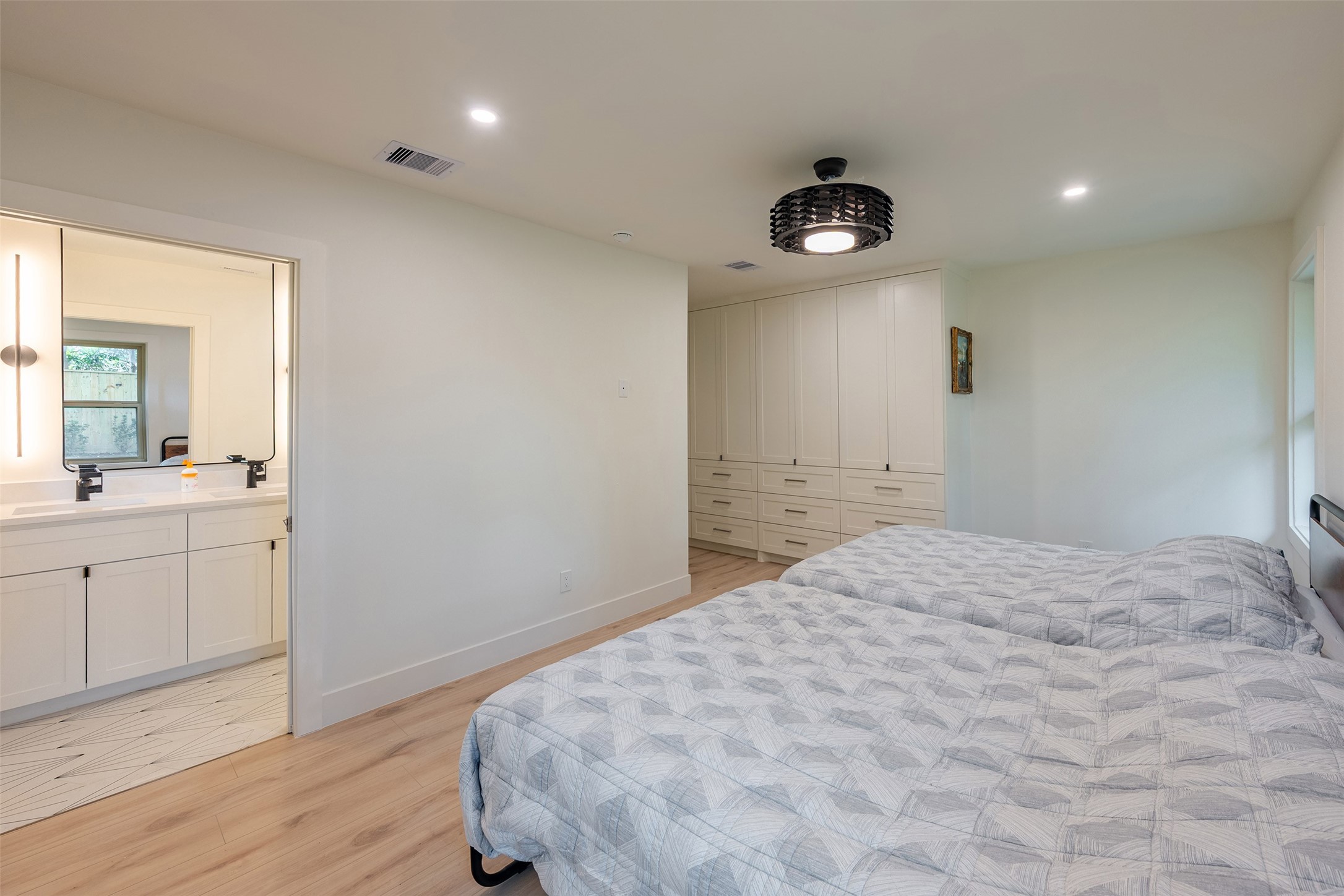 5326 Carew Street Houston, TX 77096 - Photo 18 of 30 a bedroom with a bed and a dresser