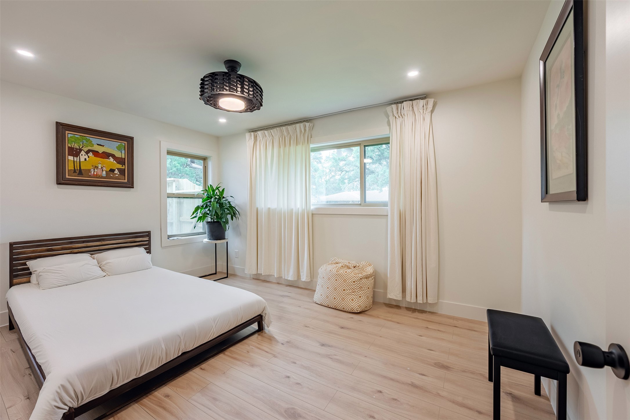 5326 Carew Street Houston, TX 77096 - Photo 20 of 30 a bedroom with a bed and a potted plant