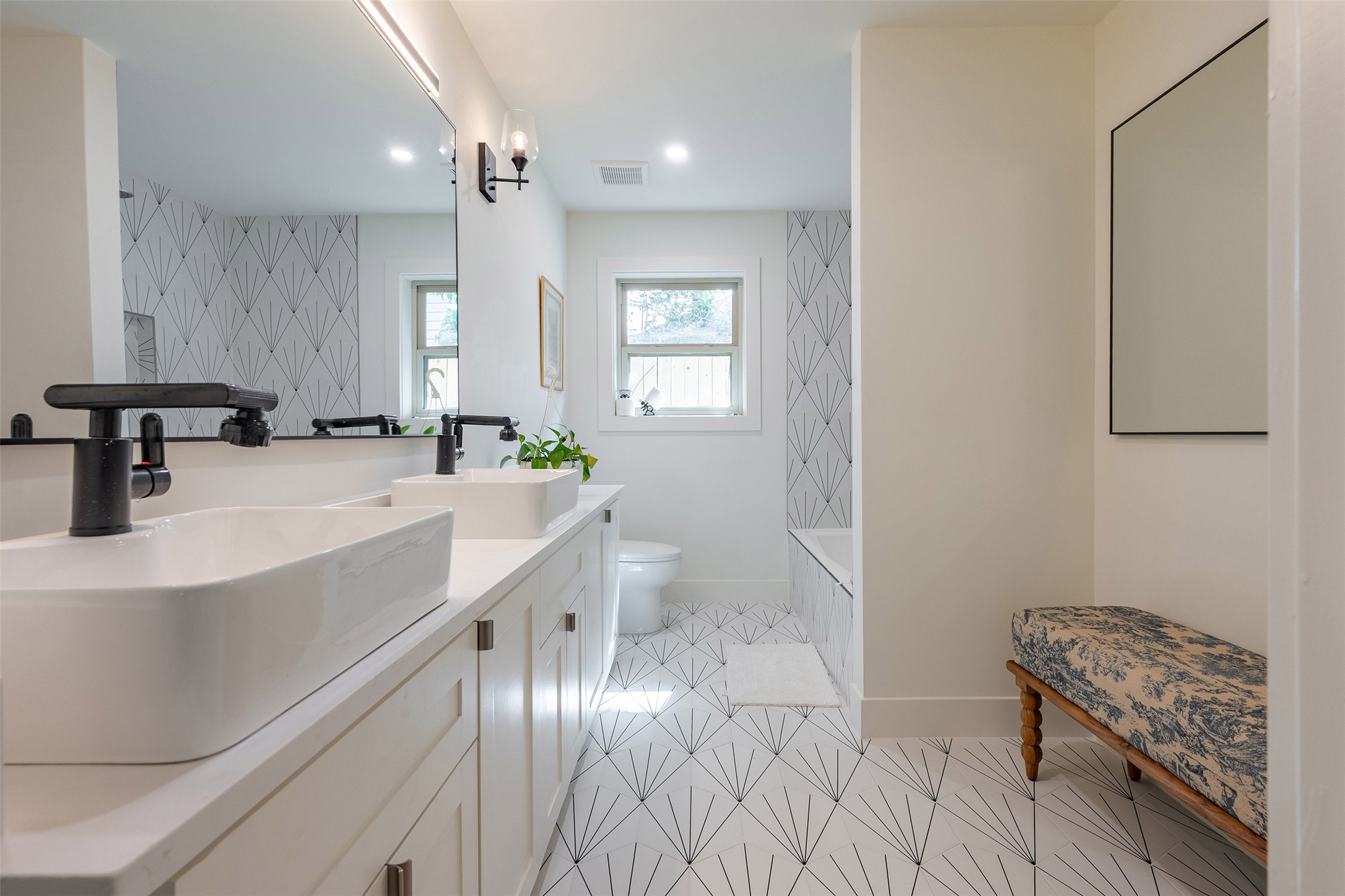 5326 Carew Street Houston, TX 77096 - Photo 22 of 30 a bathroom with a sink a large mirror and a toilet