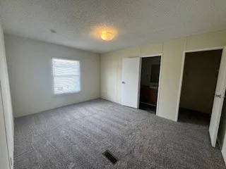 a bathroom with a granite countertop sink toilet a mirror and shower