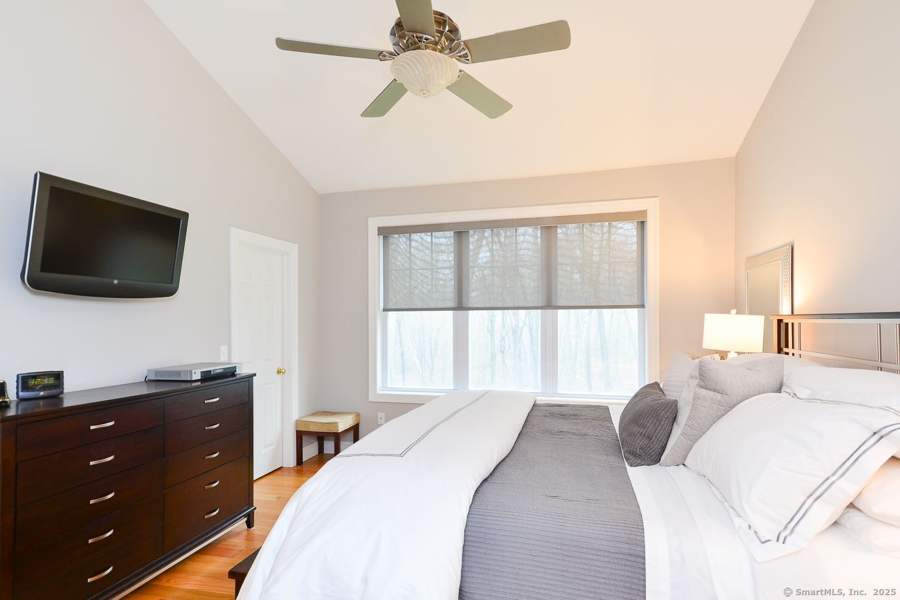 10 Fort Hill Road, Unit 3B Groton, CT 06340 - Photo 14 of 24 a bedroom with a bed and a flat screen tv